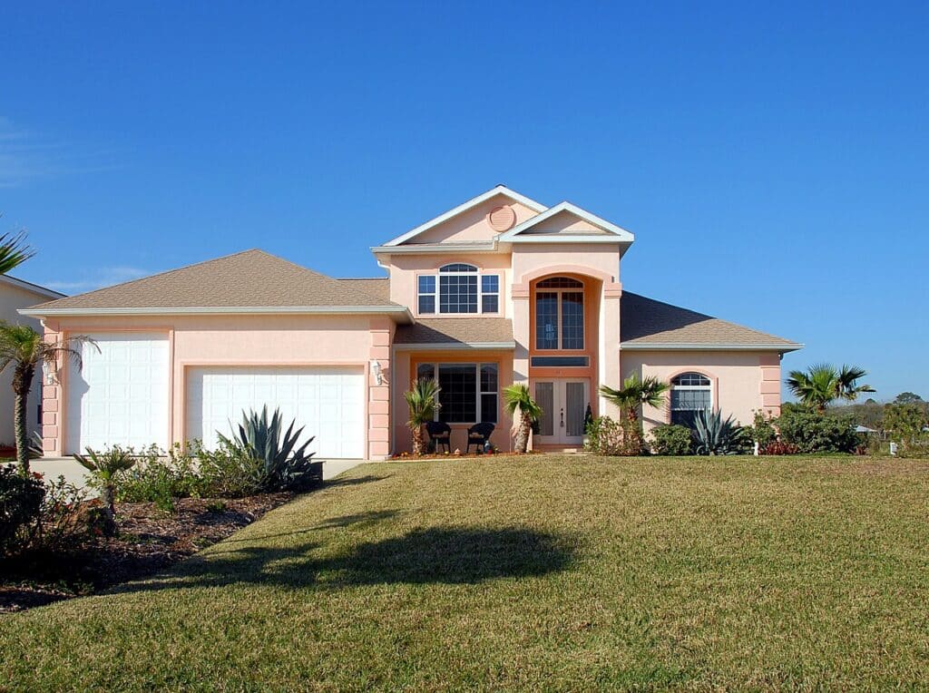 A quaint home is situated on a lawn.