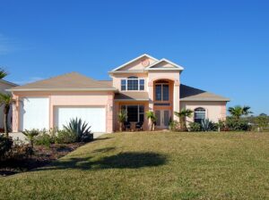 A quaint home is situated on a lawn.